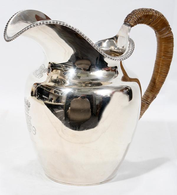 GEORGE III STERLING WATER PITCHER, 1818-19, : GEORGE III STERLING WATER PITCHER, J. E. TERRY & CO., LONDON, 1818-19, H 8 1/4":A sterling silver water pitcher of helmet shape with gadrooned rim and wrapped handle; engraved script monogram below th