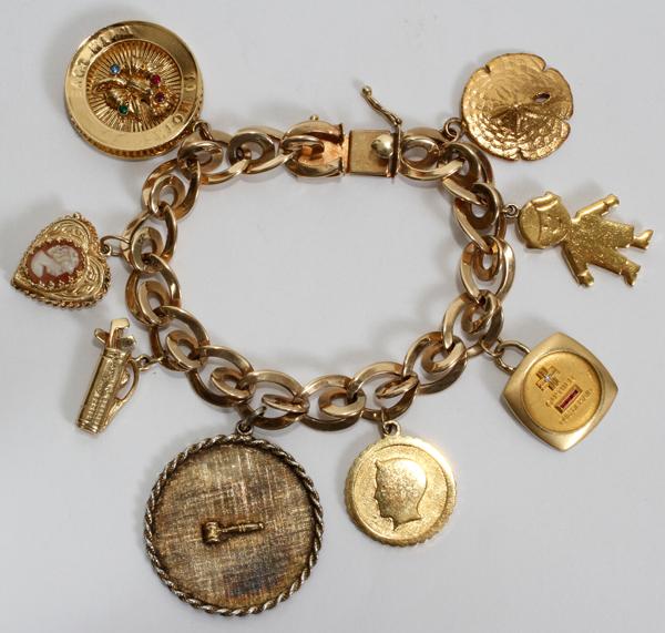 LADY'S 14 KT. GOLD CHARM BRACELET: LADY'S 14 KT. GOLD CHARM BRACELET:Featuring eight charms, 57 grams;