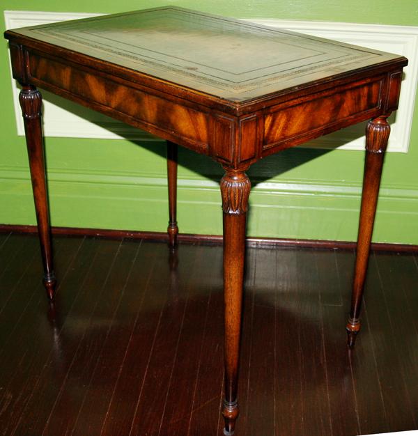 MAHOGANY SINGLE DRAWER TABLE, H 27", W 28": MAHOGANY SINGLE DRAWER TABLE, H 27", W 28":having a tooled leather top with gold leaf floral designs; small drawer on one end with tapered and turned legs with carved floral designs at top of each leg