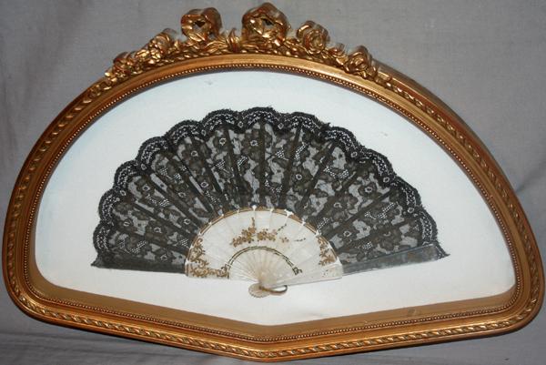 FRAMED MOTHER-OF-PEARL FAN, C1900, H 14", W 20": FRAMED MOTHER-OF-PEARL FAN, C1900, H 14", W 20":having pearlescent ribs with gilt floral highlights, black lace embroidered floral design fan, gilt wood shadow box framed under glass.