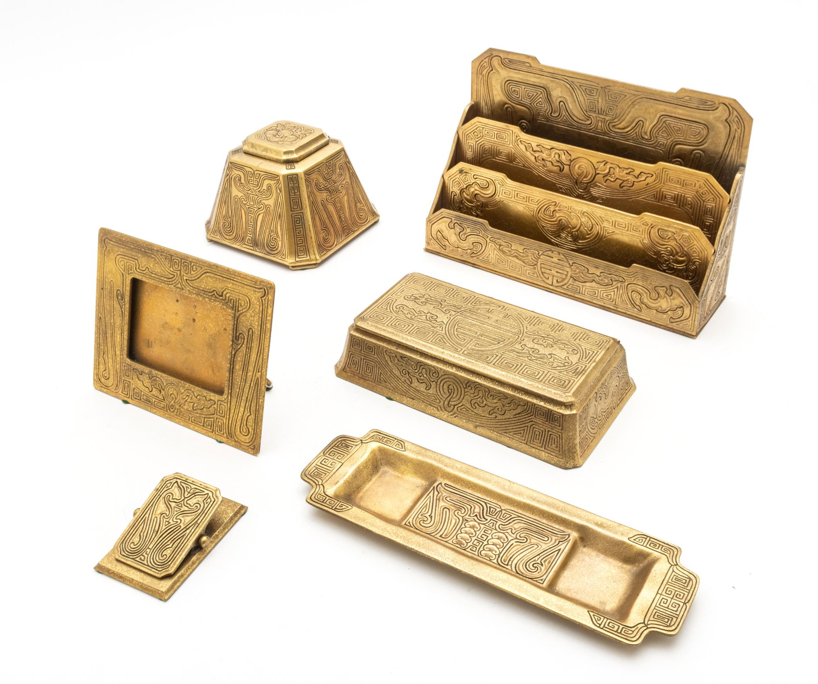 TIFFANY STUDIOS (NEW YORK) 'CHINESE' GILT BRONZE DESK: TIFFANY STUDIOS (NEW YORK) 'CHINESE' GILT BRONZE DESK SET, C. 1900, 6 PCS, L 3.5"-12" A collection of six Tiffany Studios 'Chinese' gilt bronze desk set. Includes a letter holder H 8" x W 11.5" (#1765