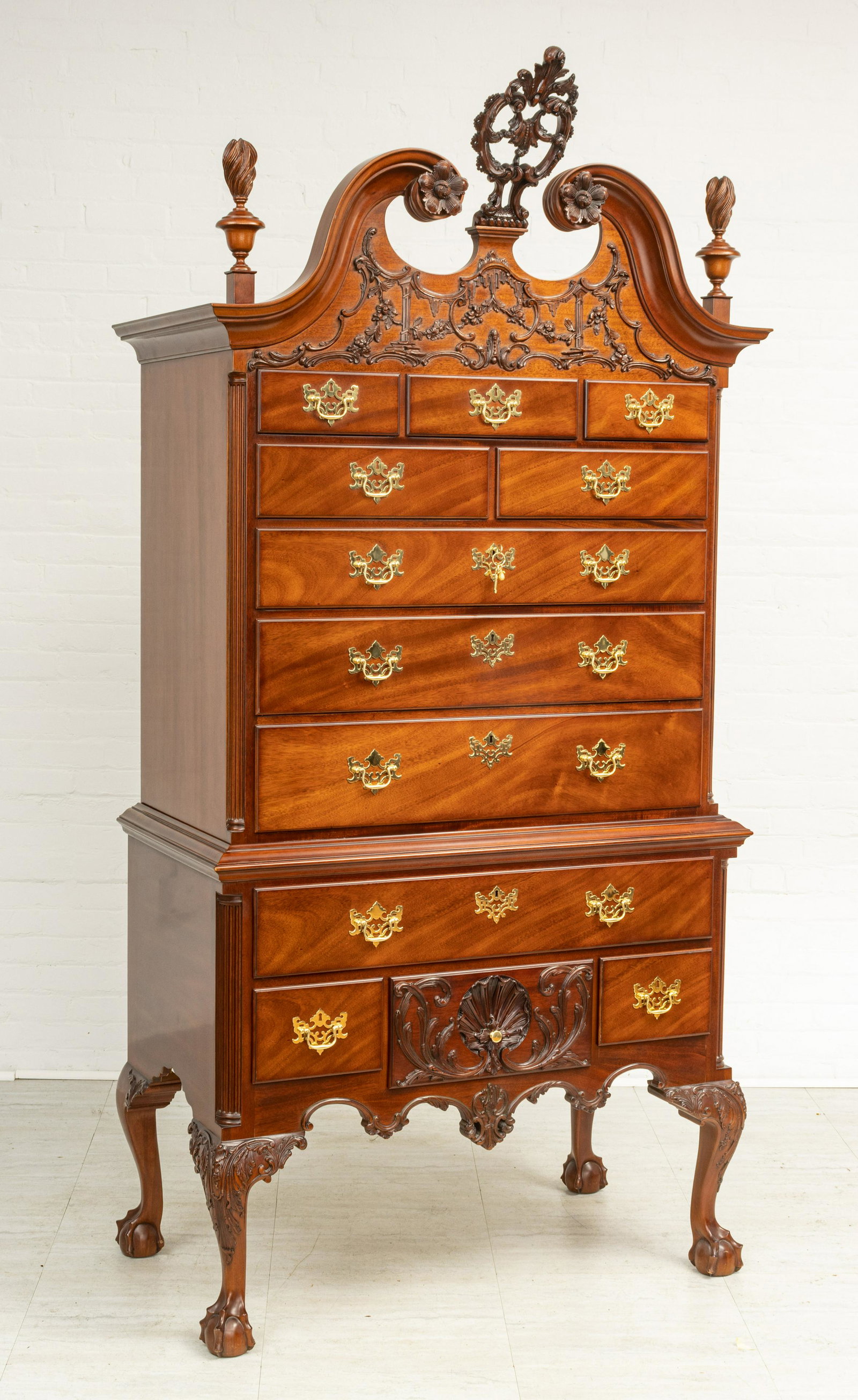 KINDEL 'WINTERTHUR REPRODUCTION' MAHOGANY HIGHBOY, H 7': KINDEL 'WINTERTHUR REPRODUCTION' MAHOGANY HIGHBOY, H 7' 4", W 3' 9" A Chippendale Philadelphia exemplar style mahogany highboy by Kindel. Having an elaborately carved filigree finial centering a scrol