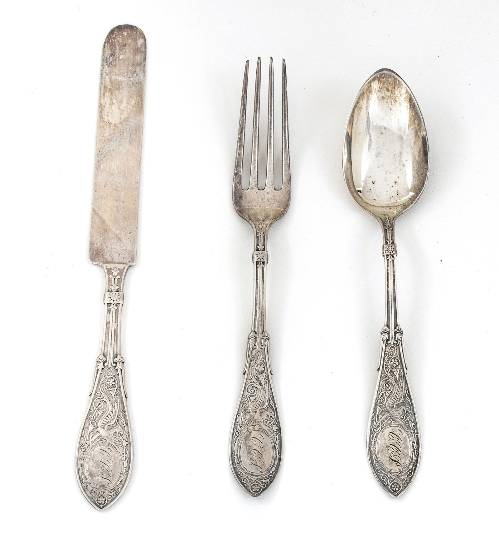 W.K. VANDERSLICE & CO. STERLING SILVER FLATWARE, C.: W.K. VANDERSLICE & CO. STERLING SILVER FLATWARE, C. 1900, 3 PCS, L 6"-7", T.W. 2.57 TOZ Engraved griffin design. knife L 7", spoon, fork L 6", monogrammed.