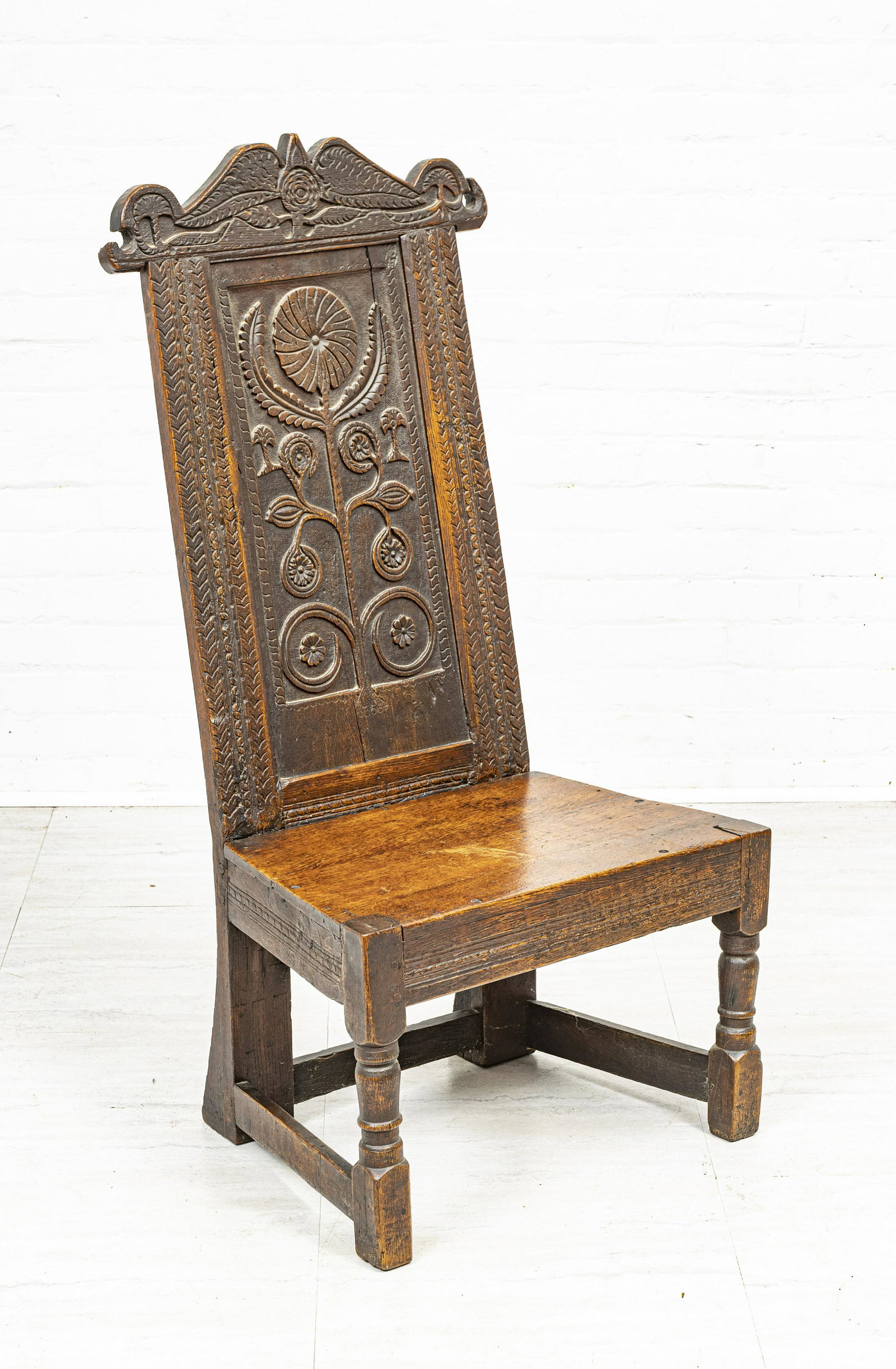 GOTHIC STYLE CARVED OAK HALL CHAIR, H 46", W 22.5": GOTHIC STYLE CARVED OAK HALL CHAIR, H 46", W 22.5" A Gothic style carved oak hall chair. Depth 15".