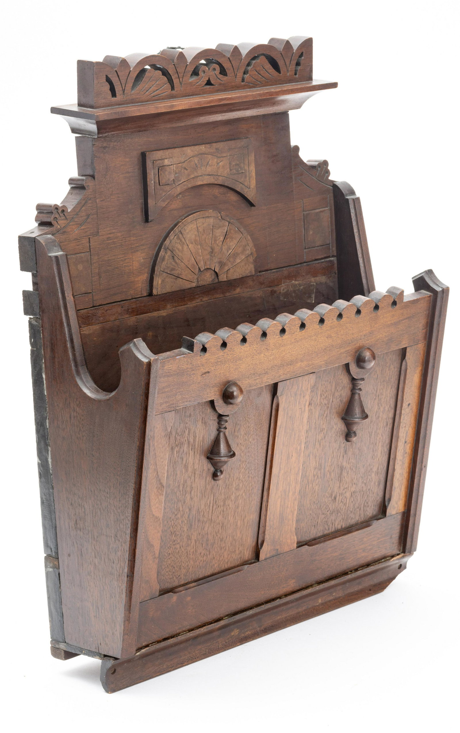 AMERICAN EASTLAKE WALNUT WALL MOUNT SHEET HOLDER C.1870: AMERICAN EASTLAKE WALNUT WALL MOUNT SHEET HOLDER C.1870 H 21" W 16" D 6.25" Wall-mounted pocket shelf. With fan and panel design with bell drop appliques. Forward canted pocket.