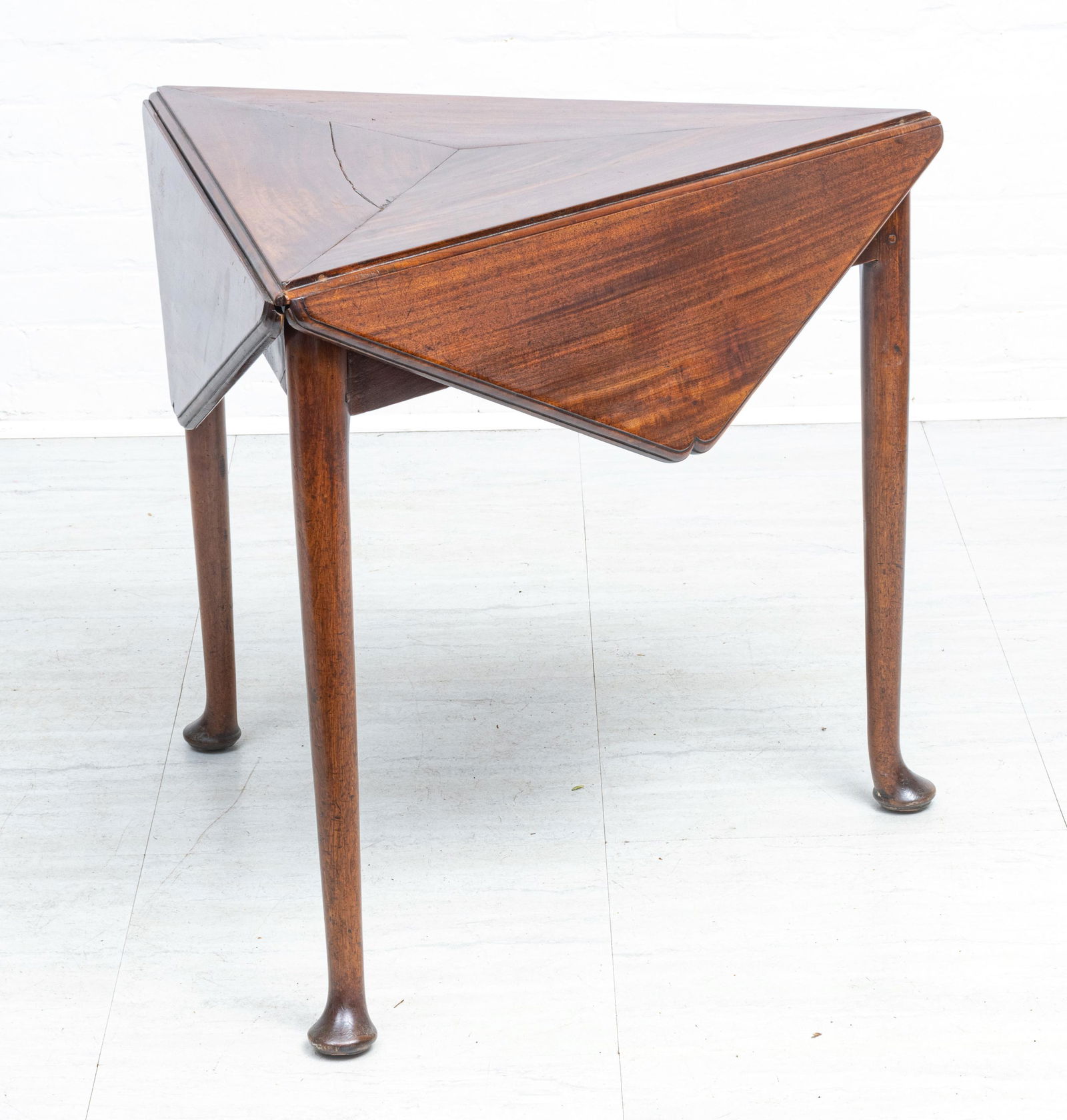 MAHOGANY DROP LEAF AND REVOLVING TRIANGULAR QUEEN ANNE: MAHOGANY DROP LEAF AND REVOLVING TRIANGULAR QUEEN ANNE STYLE TABLE C 1940 H 27" W 31" Table is triangular when closed (W 31") and hexagonal when open. Top swivels to expand and support leaves.