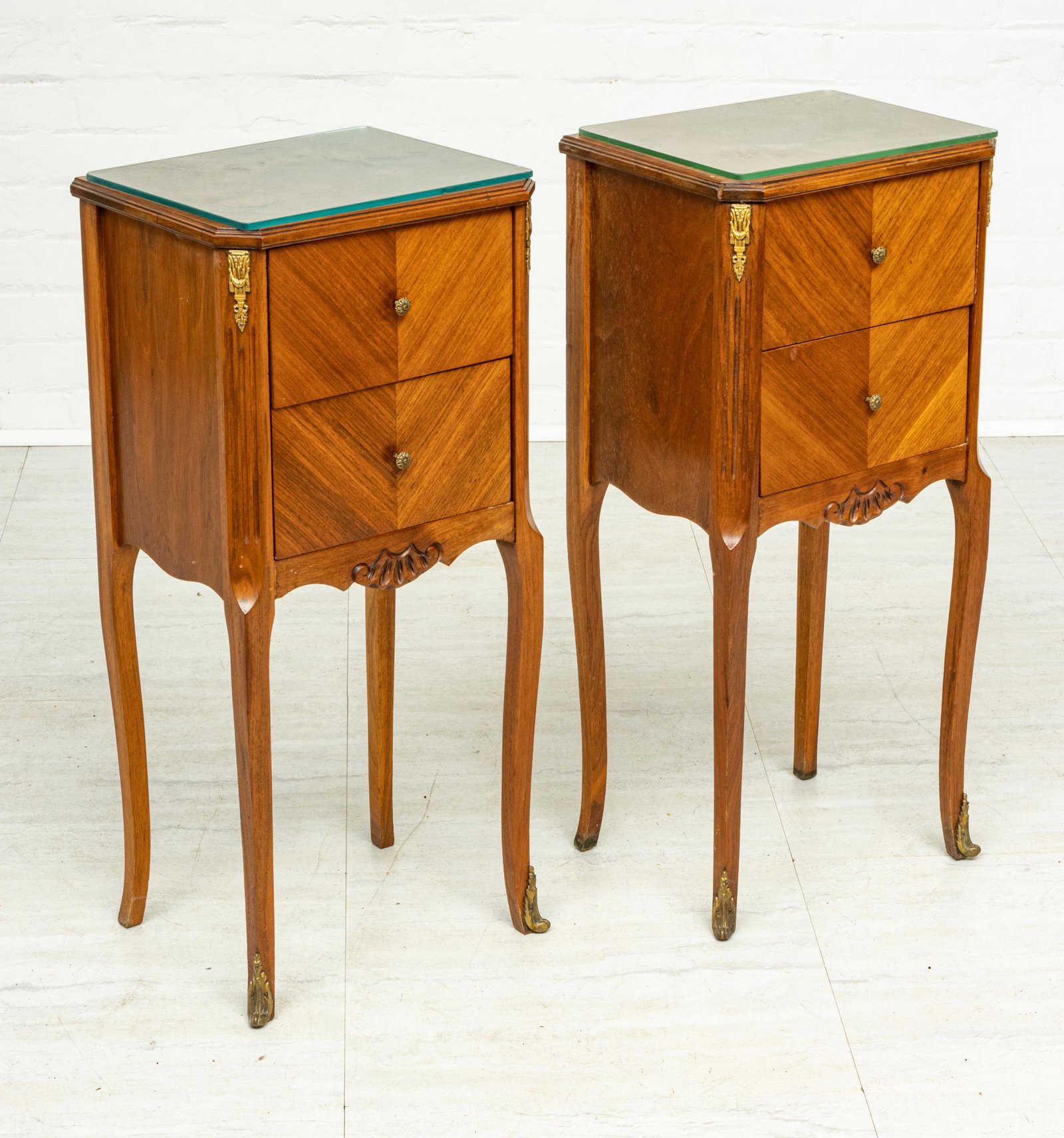 FRENCH LOUIS XV STYLE FRUITWOOD END TABLES C 1930,: FRENCH LOUIS XV STYLE FRUITWOOD END TABLES C 1930, PAIR H 30" W 13" D 10" Fruitwood. Two drawers. bronze corner mounts. Glass tops. Provenance: Estate of Joan Young, Kalamazoo, Mi.