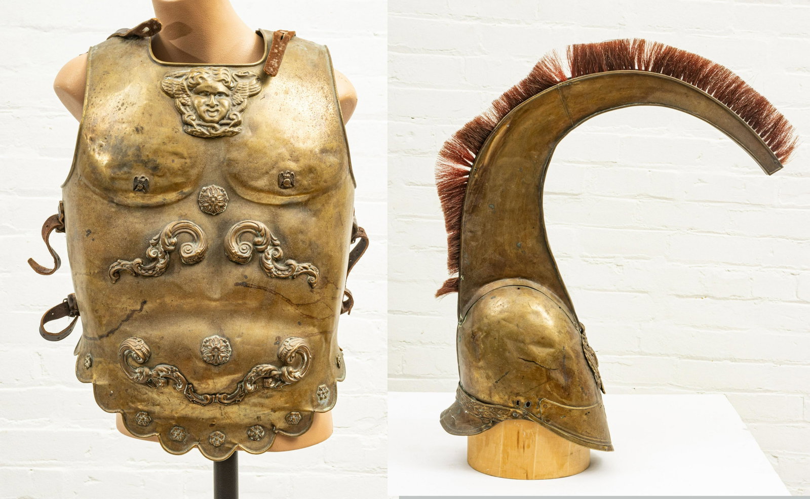 ROMAN STYLE BRASS CUIRASS AND AN AUSTRO-HUNGARIAN BRASS: ROMAN STYLE BRASS CUIRASS AND AN AUSTRO-HUNGARIAN BRASS HELMET, 20TH C., H 21", W 14" Roman-style brass armor with a Gorgon head and Roman eagle decorations. The front and back portions are connected 