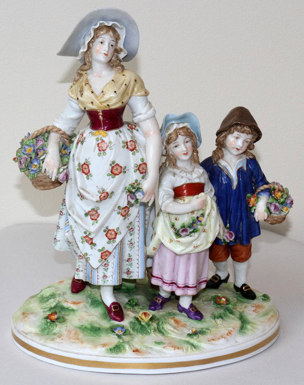 GERMAN PORCELAIN FIGURE GROUP, H 11 1/2", : GERMAN PORCELAIN FIGURE GROUP, H 11 1/2", W 9 1/2":A mother and two children gathering flowers; marked in blue at the underside (see additional photo). From the collection of Joseph and Norina Simon, 