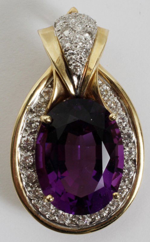 14.5CT AMETHYST AND DIAMOND GOLD LAVALIER: 14.5CT AMETHYST AND DIAMOND GOLD LAVALIER:14.5ct oval amethyst set with 37 single cut diamonds on a 14kt yellow gold lavalier. From the collection of Joseph and Norina Simon, Grosse Pointe Farms, Mi.