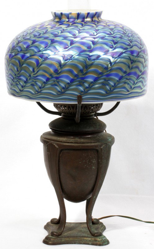LUNDBERG STUDIOS ART GLASS SHADE, 1984, DIA 8": LUNDBERG STUDIOS ART GLASS SHADE, 1984, DIA 8", WITH TIFFANY STYLE LAMP BASE:An iridescent domed glass shade signed and dated "Lundberg Studios 1984" raised on a patinated metal urn-form base, not mar