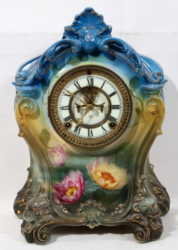 ROYAL BONN, ANSONIA WORKS CHINA MANTEL CLOCK, : ROYAL BONN, ANSONIA WORKS CHINA MANTEL CLOCK, C. 1890, H 14", W 11":Very decorative china case mantle clock. Motif of water lilies, Brass works by Ansonia Clock Co., New York. With "Ansonia" key. Pend