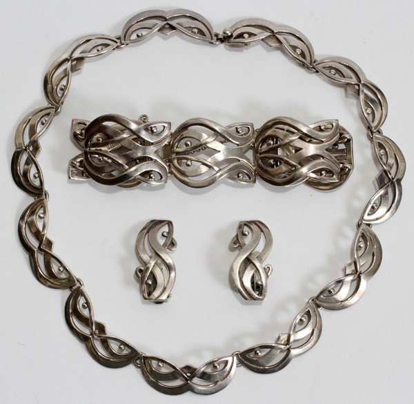 JOSE LUIS FLORES MEXICAN TAXCO SILVER NECKLACE: JOSE LUIS FLORES MEXICAN TAXCO SILVER NECKLACE, BRACELET & PAIR OF EARRINGS THREE PIECES:Necklace in the design of masquerade eyes and marked JLF Sterling Taxco 1025. The bracelet and clip earrings ar