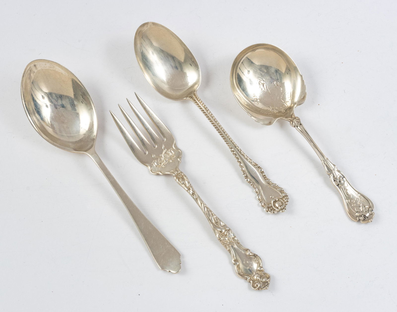 STERLING SILVER SERVING SPOONS AND FORK LOT OF FOUR: STERLING SILVER SERVING SPOONS AND FORK LOT OF FOUR 9.96TO Dominic and Haff serving spoon 9" no monogram; Birks serving spoon; Whiting Gorham serving spoon, Wallace Silversmiths "Eton" serving fork. (