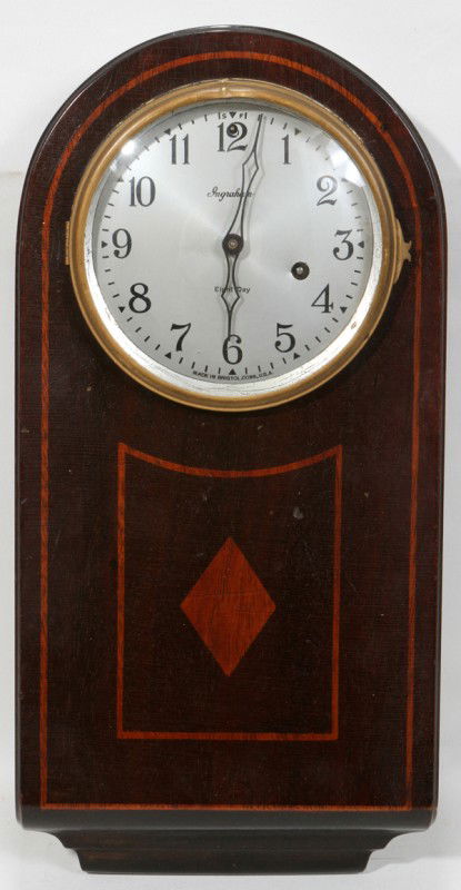 INGRAHAM EIGHT-DAY MAHOGANY WALL CLOCK, H 16": INGRAHAM EIGHT-DAY MAHOGANY WALL CLOCK, H 16":having an arched top; diamond pattern and narrow border fruit wood inlays on front of case; inscribed on bottom of face: 'Made In Bristol, Conn. U.S.A.';