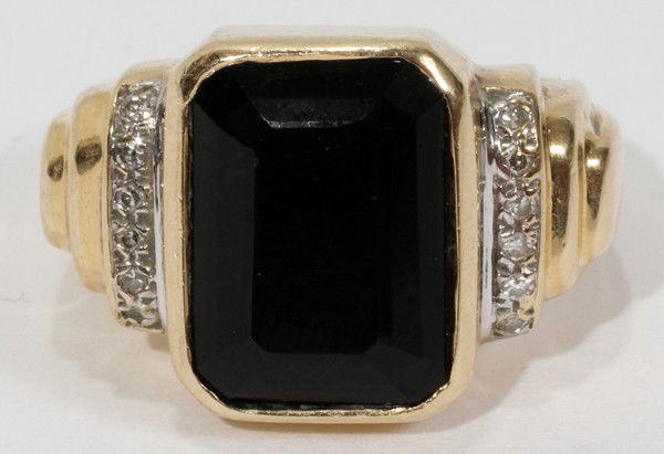 14KT YELLOW GOLD BLACK ONYX AND DIAMOND RING: 14KT YELLOW GOLD BLACK ONYX AND DIAMOND RING:14kt yellow gold ring set with a black onyx center stone with 12 accent diamonds. Weighs 9 grams total. From the collection of Joseph and Norina Simon, Gro
