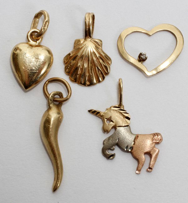YELLOW GOLD CHARMS, FIVE: YELLOW GOLD CHARMS, FIVE:Most of which are marked 14kt; including a heart, shell, pierced heart with diamond, Italian horn, and a tri-color unicorn. From the collection of Joseph and Norina Simon, Gro