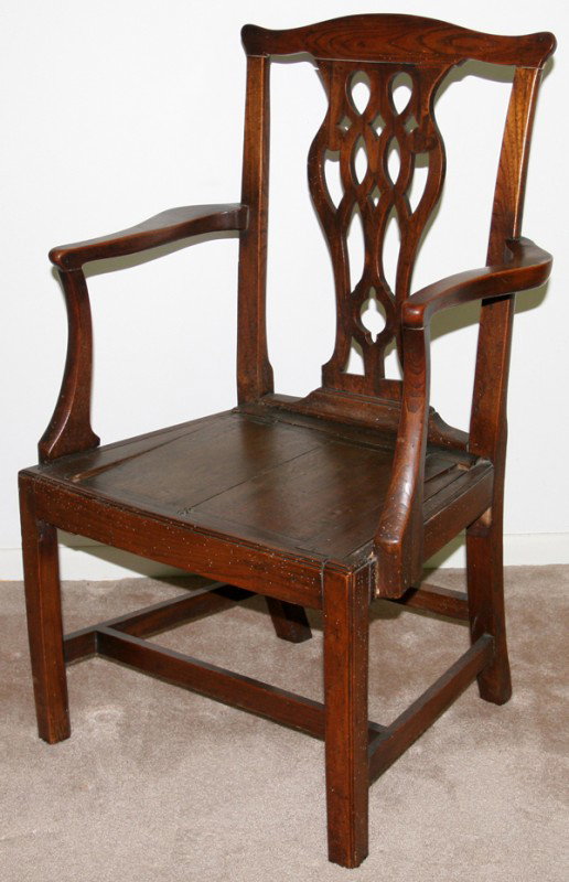 ENGLISH CHIPPENDALE OAK ARMCHAIR, ANTIQUE: ENGLISH CHIPPENDALE OAK ARMCHAIR, ANTIQUE:A shaped chair rail above a pierced back splat, raised on rectilinear supports joined by stretchers.