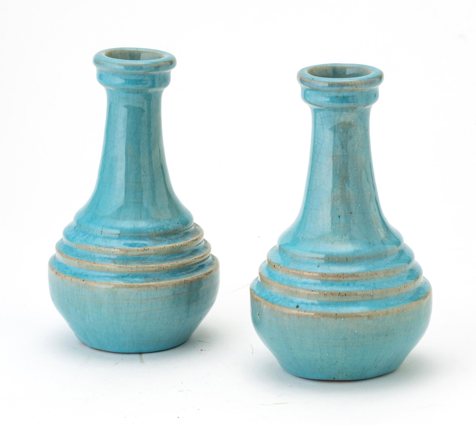 PEWABIC POTTERY PERSIAN BLUE GLAZE POTTERY VASES, C. 1938-1967 PAIR H 5.75" DIA 3.25": PEWABIC POTTERY PERSIAN BLUE GLAZE POTTERY VASES, C. 1938-1967 PAIR H 5.75" DIA 3.25" Pewabic white clay body, turquoise glaze with reduction. One marked with the "Pewabic Detroit" medallion mark in t