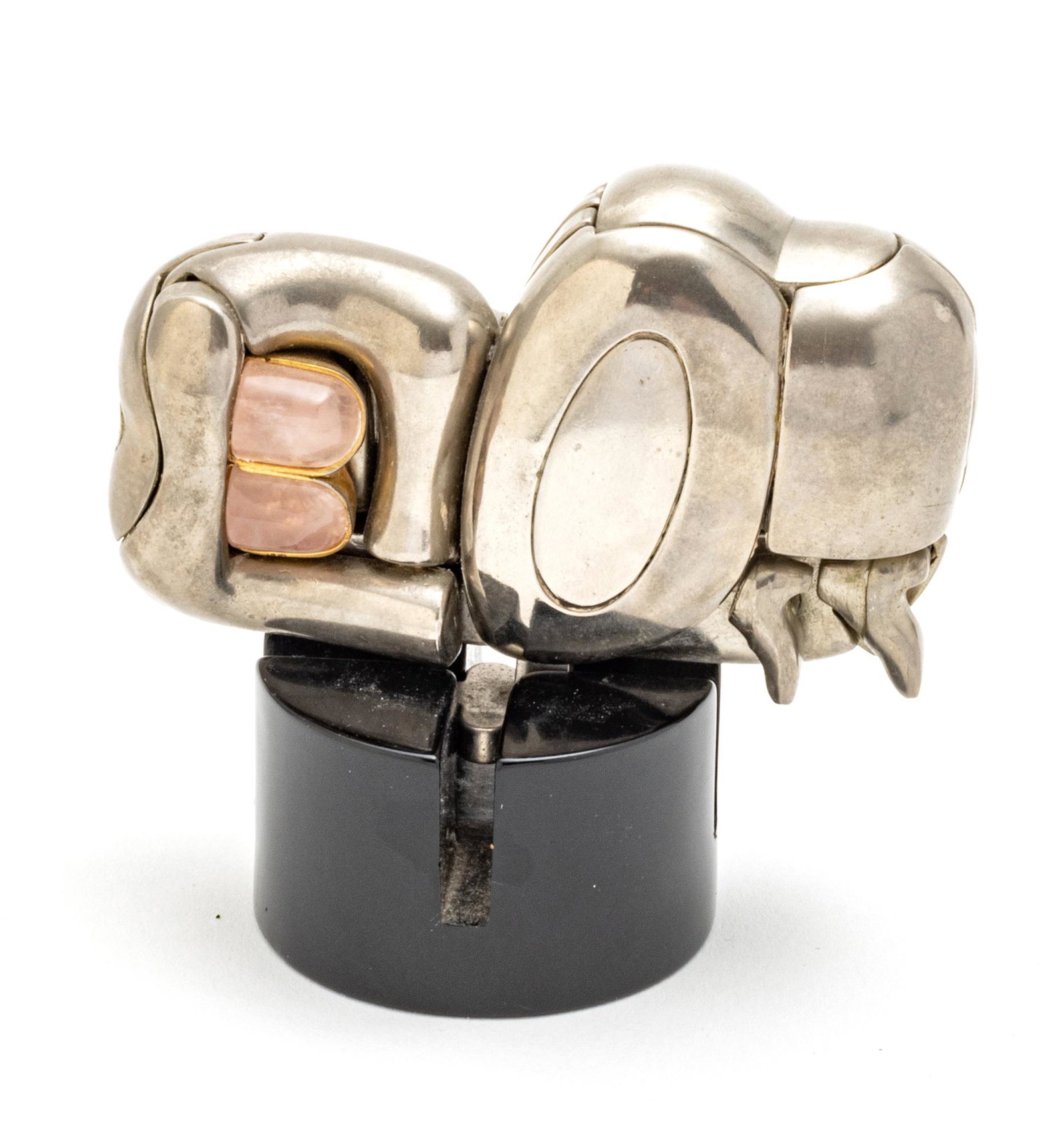 MIGUEL ORTIZ BERROCAL (SPAIN 1933-2006) SILVERED BRASS PUZZLE SCULPTURE, H 2", "MINI ZORAIDA": MIGUEL ORTIZ BERROCAL (SPAIN 1933-2006) SILVERED BRASS PUZZLE SCULPTURE, H 2", "MINI ZORAIDA" A silvered brass puzzle sculpture with rose quartz accents titled "Mini Zoraida" by Miguel Ortiz Berrocal.