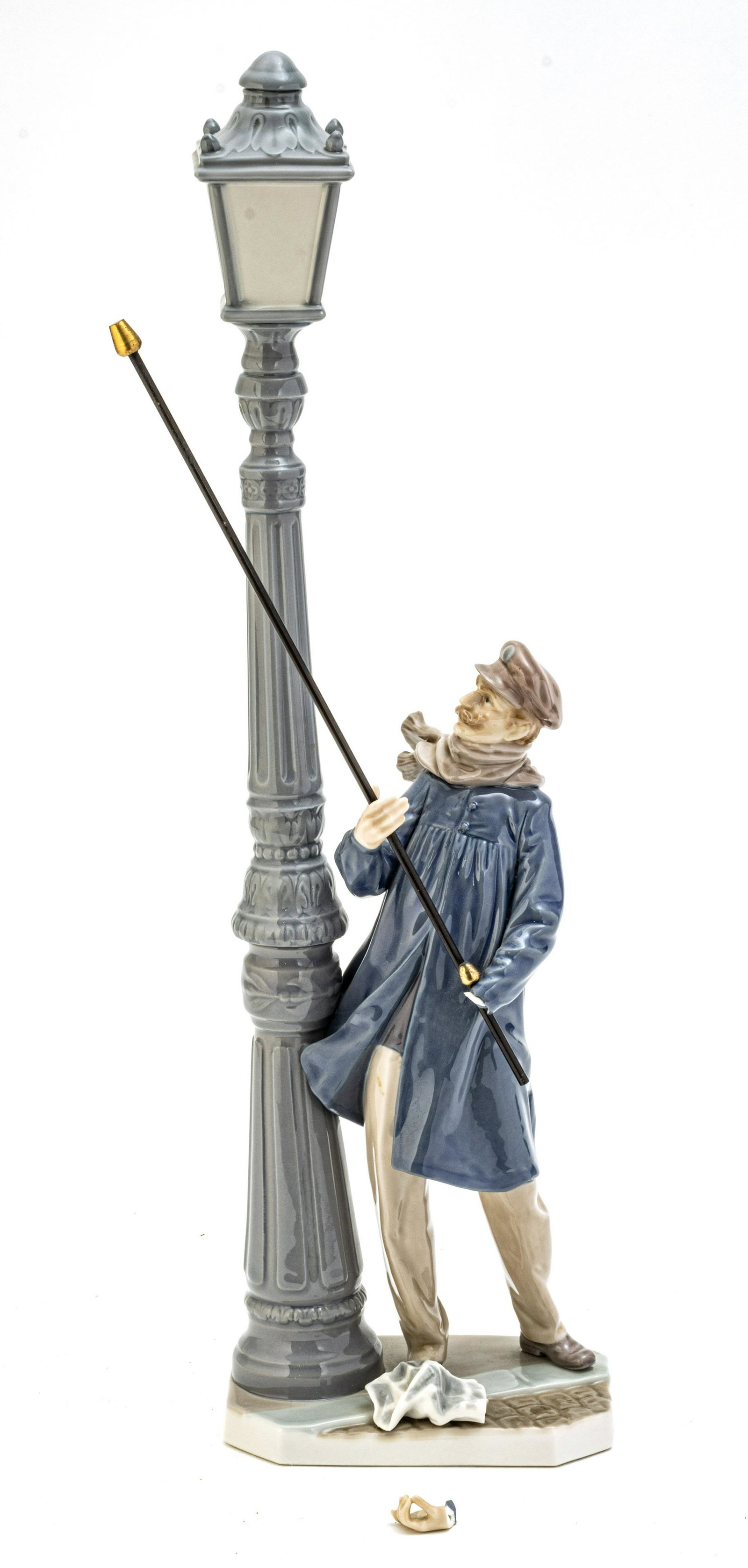 LLADRÓ (SPANISH, 1953) PORCELAIN SCULPTURE DEPICTING A MAN LIGHTING A STREET LAMP, 1984 H 19": LLADRÓ (SPANISH, 1953) PORCELAIN SCULPTURE DEPICTING A MAN LIGHTING A STREET LAMP, 1984 H 19" W 5.5" "EL FAROLERO" ("LAMPLIGHTER") Marked on the underside. Comes with original box.