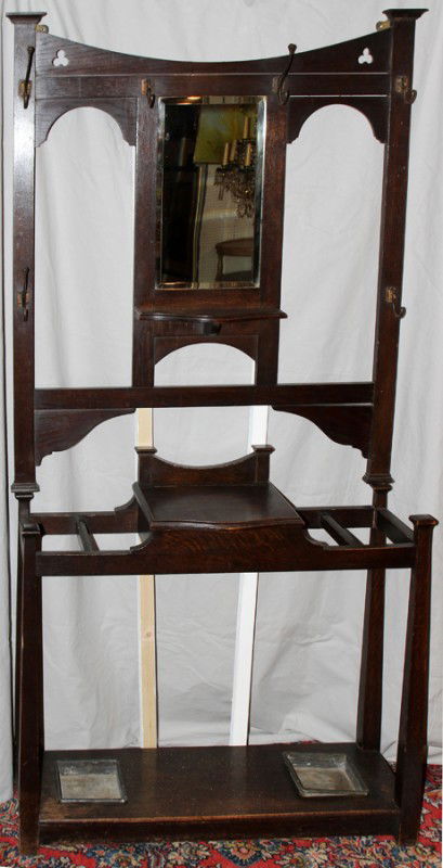 AMERICAN OAK WALL MOUNTED HALL TREE,H 75",: AMERICAN OAK WALL MOUNTED HALL TREE, EARLY 20TH C., H 75", L 36":Featuring a hat and coat rack with umbrella stand with removable rectangular metal drip trays at the bottom.