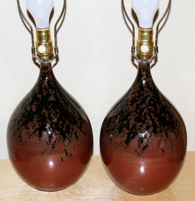 CONTEMPORARY GLAZED CERAMIC TABLE LAMPS, PAIR,: CONTEMPORARY GLAZED CERAMIC TABLE LAMPS, PAIR, H 12":Having an abstract spatter pattern from brown to black to a brownish red. No apparent markings. Includes harps and shades.