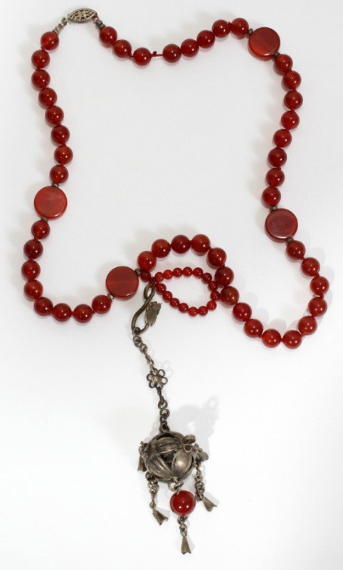 CARNELIAN NECKLACE WITH SILVER PENDANT, L 18": CARNELIAN NECKLACE WITH SILVER PENDANT, L 18":a silver pendant suspended from carnelian stone beads of ruby red color; silver clasp;