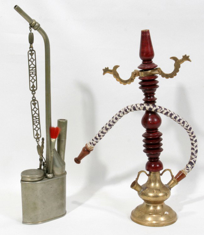 CHINESE & INDIAN OPIUM PIPES, L 11" & 12": CHINESE & INDIAN OPIUM PIPES, L 11" & 12":Indian pipe is brass, wood and fabric, 11'' x 5''. Chinese pewter pipe is 12" x 3 ''. Chinese pipe with accessories: brush, tong container and three tubes.