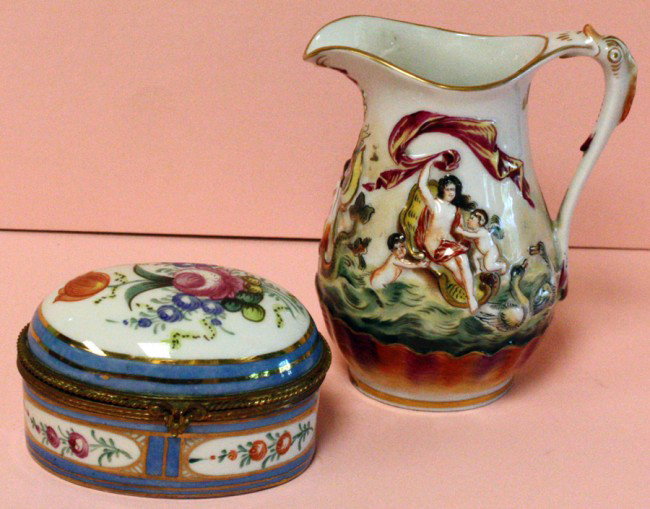 LIMOGES PORCELAIN COVERED BOX & PITCHER, H 4": LIMOGES PORCELAIN COVERED BOX & CAPO DI MONTE PITCHER, H 4":Oval box with floral decoration with blue border, L 3 1/4". Signed "Made in France"; hand painted on bottom. Pitcher has a sea scene with go
