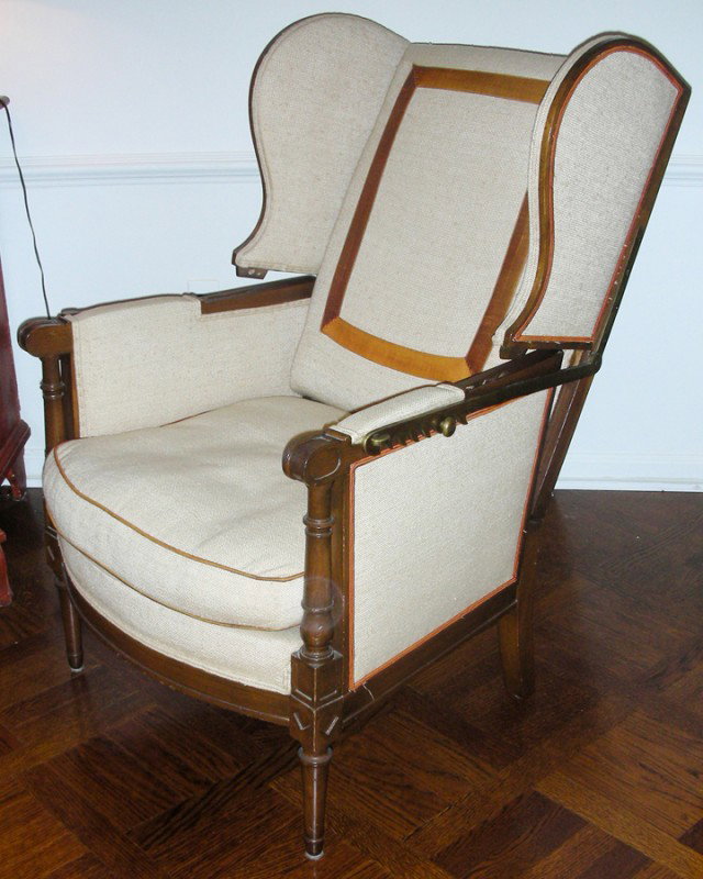 WALNUT WINGBACK CHAIR, WITH ADJUSTABLE BACK: WALNUT WINGBACK CHAIR, WITH ADJUSTABLE BACK:Having a brass mechanism to adjust the back. Upholstered in a linen fabric; loose cushion. From the estate of Elsie Epstein. H 41", L 27", D 30"