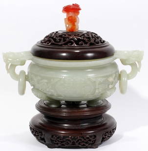 CHINESE JADE CENSER WITH WOOD COVER, H 6 1/2": CHINESE JADE CENSER WITH WOOD COVER, H 6 1/2", W 8 1/2":Having a pierced wood cover, with a carved carnelian finial, that rests atop a carved jade bowl with dragon masks with rings at either side, all