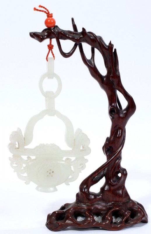 CHINESE CARVED PALE CELADON JADE HANGING URN: CHINESE CARVED PALE CELADON JADE HANGING URN & WOOD STAND, H 5" OVERALL:Pale celadon jade vase of flattened baluster form with two carved scrolling handles and three loose rings connected to an overhe