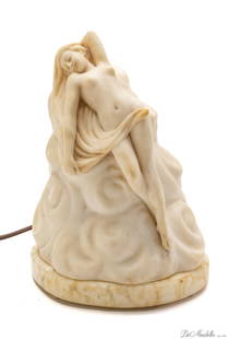 ITALIAN ALABASTER AND MARBLE CARVED FIGURAL NUDE RECLINING ON WAVES, NIGHT LAMP, C 1920 H 11": ITALIAN ALABASTER AND MARBLE CARVED FIGURAL NUDE RECLINING ON WAVES, NIGHT LAMP, C 1920 H 11" Nude female figure resting on waves. In two parts. Electric lamp. Inscribed Made in Italy on the edge