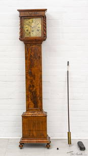 ENGLISH WALNUT GRANDMOTHER CLOCK, 19TH C, H 5' 5", W 1' 2": ENGLISH WALNUT GRANDMOTHER CLOCK, 19TH C, H 5' 5", W 1' 2" A 19th century English walnut clock. Offers a molded pediment over four barley twist columns. Brass dial with iron hands with both Roman