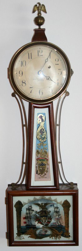 CHELSEA CLOCK CO. MAHOGANY BANJO CLOCK, H 34": CHELSEA CLOCK CO. MAHOGANY BANJO CLOCK, FEDERAL STYLE, CONSTITUTION VS. HMS GUERRIERE, C1930, H 34":Chelsea Clock Co. Boston; having a gilt metal eagle finial at the top, a metal face with Arabic Nume