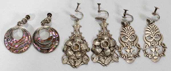 MEXICAN SILVER EARRINGS, THREE PAIRS: MEXICAN SILVER EARRINGS, THREE PAIRS:Each with screw backs and featuring concentric circles with inset abalone and marked P.C Sterling, mask form drop earrings marked Sterling Taxco and floral and lea