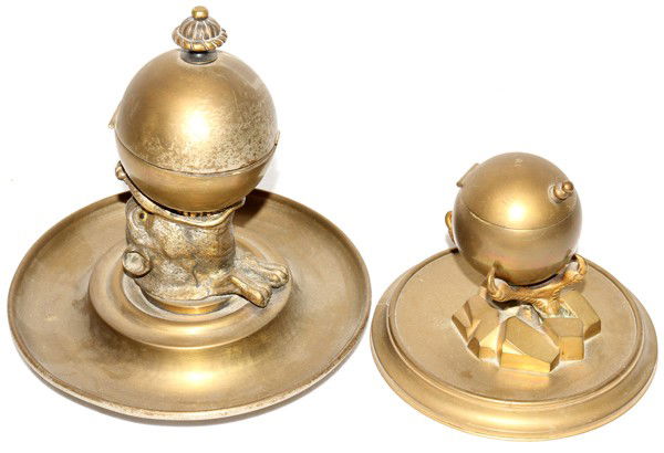 GILT METAL FIGURAL INKWELLS, C. 1900, TWO,: GILT METAL FIGURAL INKWELLS, C. 1900, TWO, H 4 1/2" & 8":Each with an orb style holder, one supported by an eagle's claw and the other by a wild boar. Heights are approximately 4 1/2" and 7 3/4".