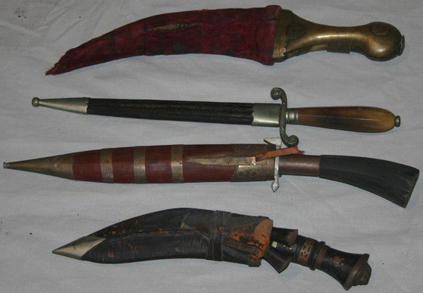 INDIAN KUKRI, PERSIAN DAGGER, ETC FOUR: INDIAN KUKRI, PERSIAN DAGGER, ETC FOUR:includes one Indian Kukri knife, 6" blade, one Karda (auxiliary knife) and Chakmak (flint striker), wood hilts, copper inlay, leather sheath; one Persian curved
