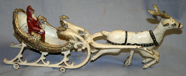 VINTAGE CAST IRON SANTA, SLEIGH AND REINDEER, : VINTAGE CAST IRON SANTA, SLEIGH AND REINDEER, C1900, H 7", L 15":depicts Santa in a red suit, riding in a sleigh with one reindeer;