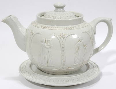 HANLEY, ENGLAND DUDSON BROS. PORCELAIN TEAPOT: HANLEY, ENGLAND DUDSON BROS. PORCELAIN TEAPOT WITH TRIVET, ANTIQUE, H 6", W 7", DIA TRIVET 6":Medallions cameo designs. Hand made white porcelain.