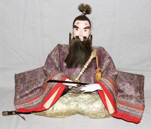 JAPANESE ANTIQUE SEATED SAMURAI FIGURE, H 14",: JAPANESE ANTIQUE SEATED SAMURAI FIGURE, H 14", W 17":With swords and costume.