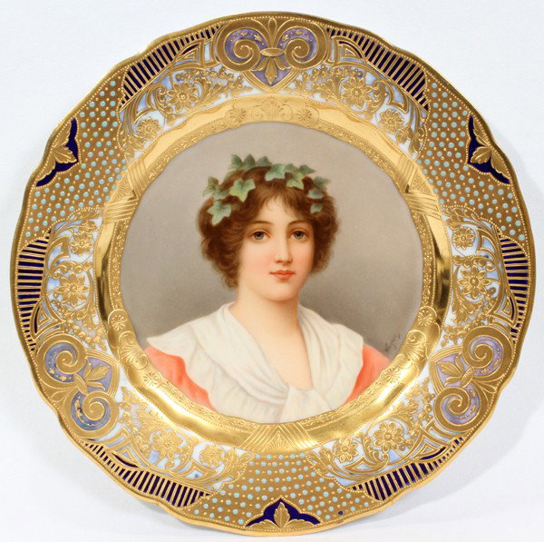 ROYAL VIENNA PORCELAIN PORTRAIT PLATE, 'IVY',: ROYAL VIENNA PORCELAIN PORTRAIT PLATE, 'IVY', SIGNED WAGNER, DIA 9 5/8":A highly decorated porcelain plate hand-painted at the well with a bust-length portrait of a young woman wearing an ivy tendril 