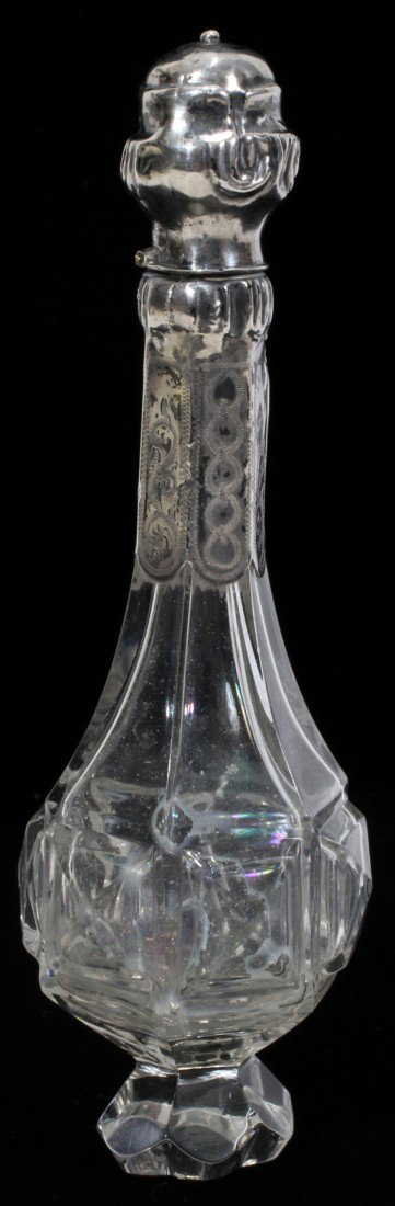 CONTINENTAL GLASS & SILVER SCENT BOTTLE, : CONTINENTAL GLASS & SILVER SCENT BOTTLE, EARLY 19TH C., L 4 3/4", PROBABLY DUTCH:A cut and faceted clear glass bottle with a silver collar and hinged cap. No apparent marks.