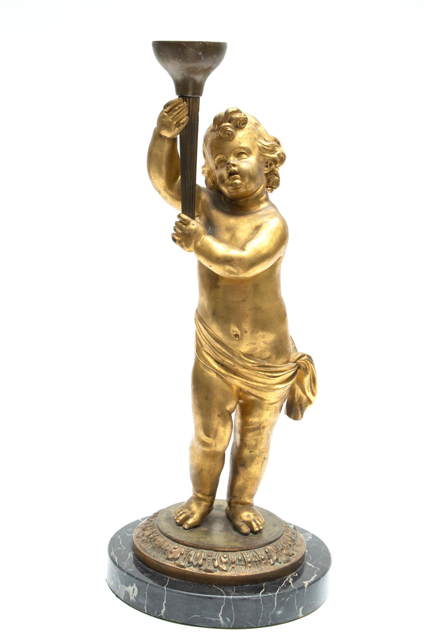 BRONZE FIGURE OF CHERUB H 20": BRONZE FIGURE OF CHERUB H 20" With marble base 21". Gold patina. Cherub carrying torch - like instrument.