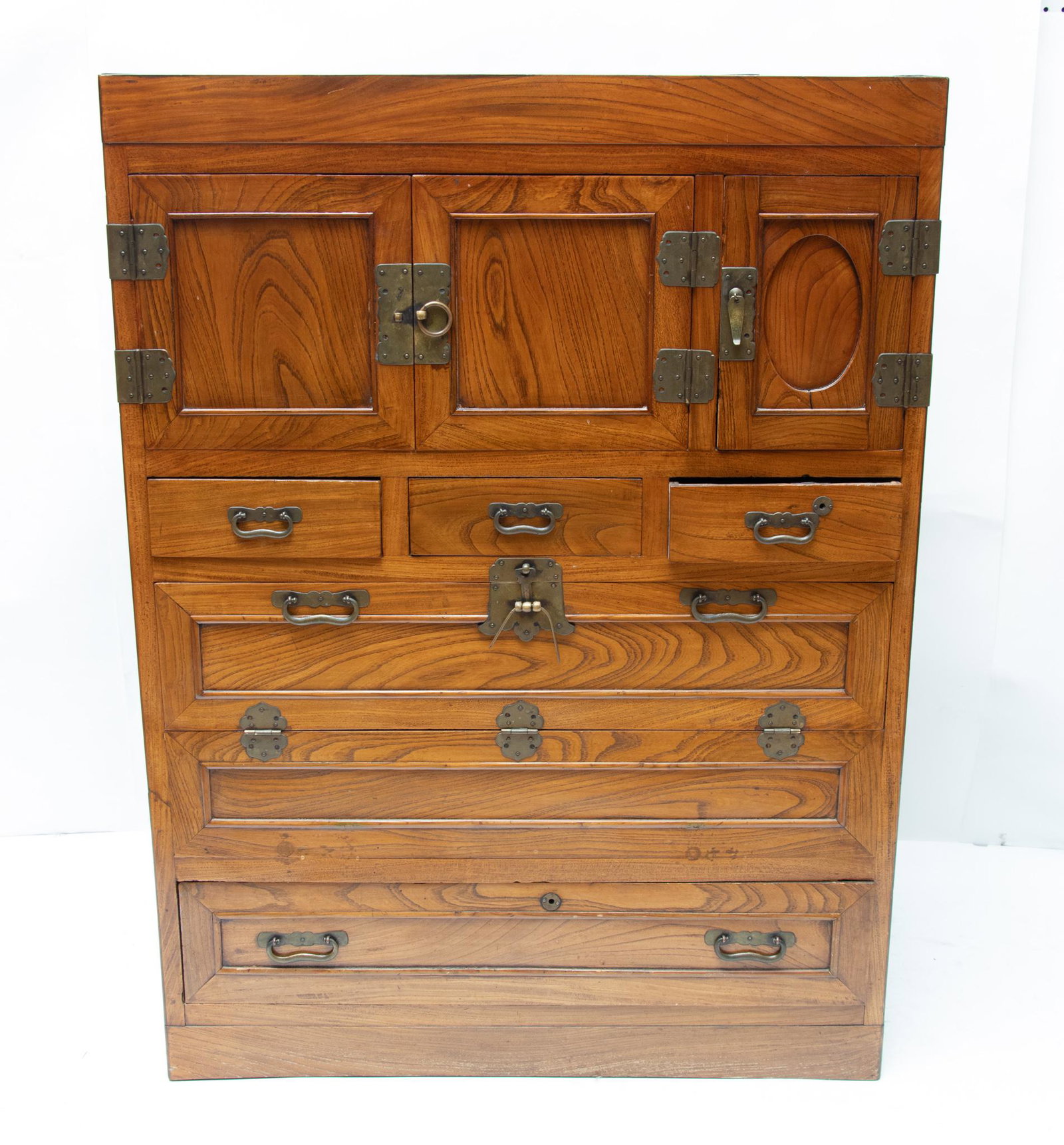 KOREAN CARVED WOOD TANSU CABINET, H 48 1/4", W 35 3/4", D 19": KOREAN CARVED WOOD TANSU CABINET, H 48 1/4", W 35 3/4", D 19" Having three upper wood paneled doors above three small drawers. Having a wood paneled drop front drawer face above a full size lower wood