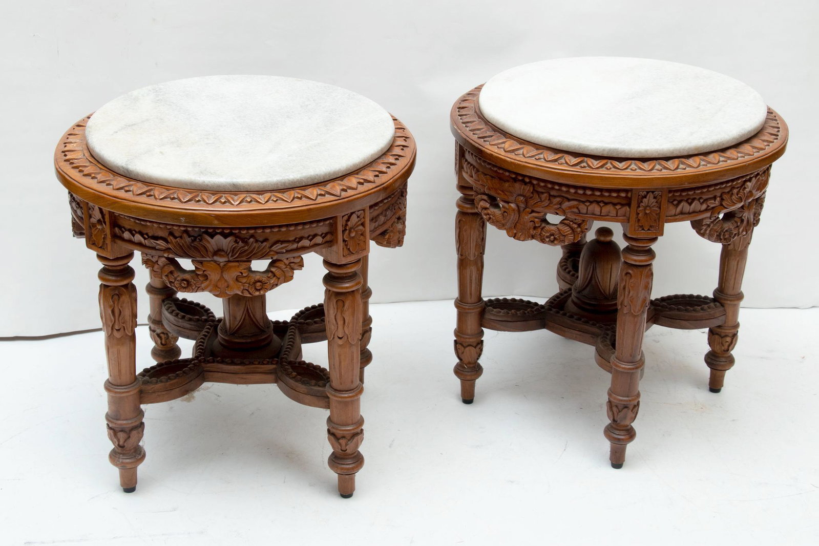 LOUIS XVI STYLE CARVED WOOD MARBLE TOP END TABLES, PAIR, H 22" DIA 21": LOUIS XVI STYLE CARVED WOOD MARBLE TOP END TABLES, PAIR, H 22" DIA 21" Carved wood floral designs on apron with four straight tapered legs. Round white and grey marle tops.