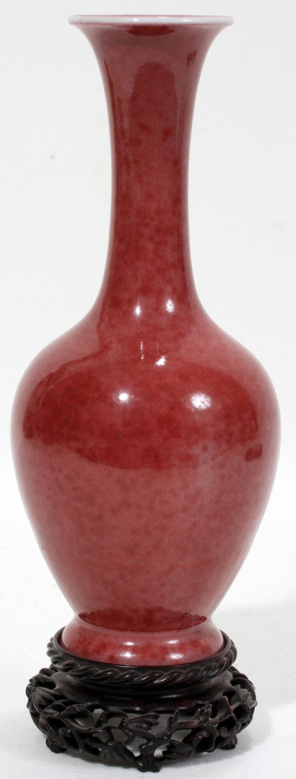 CHINESE SANG DE BOEUF PORCELAIN VASE, H 6 1/4",: CHINESE SANG DE BOEUF PORCELAIN VASE, H 6 1/4", DIA 2 1/2":Having an under glaze blue apocryphal six-character Kangxi mark at the underside (see additional photo). Includes a separated carved wood sta