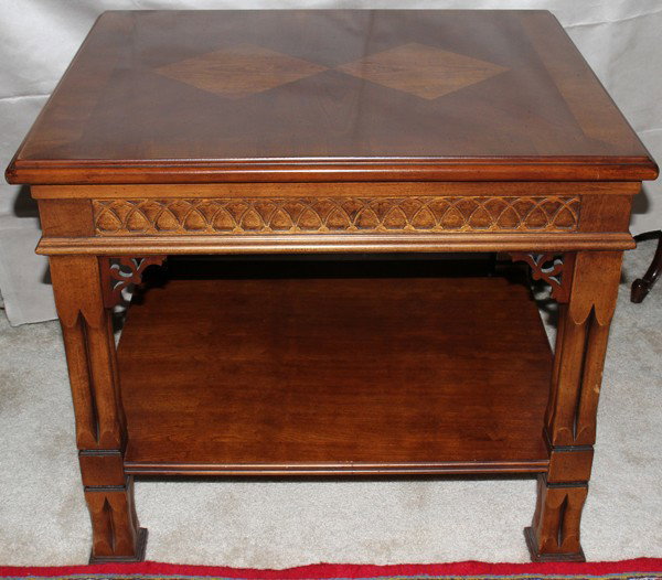 HENREDON WALNUT TABLE, H 24", W 28", D 24": HENREDON WALNUT TABLE, H 24", W 28", D 24":Having a beveled edge, blind fretwork, and raised on supports joined by a shelf stretcher.