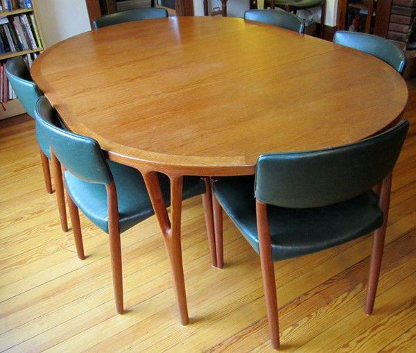 SOREN HORN TEAK DINING TABLE, AND BECK CHAIRS: SOREN HORN TEAK DINING TABLE, AND WILLY BECK DINING CHAIRS [8], CIRCA 1970:Eight Danish teak dining chairs by cabinet maker Willy Beck upholstered in blue vinyl. Teakwood round 51" dining table by cab